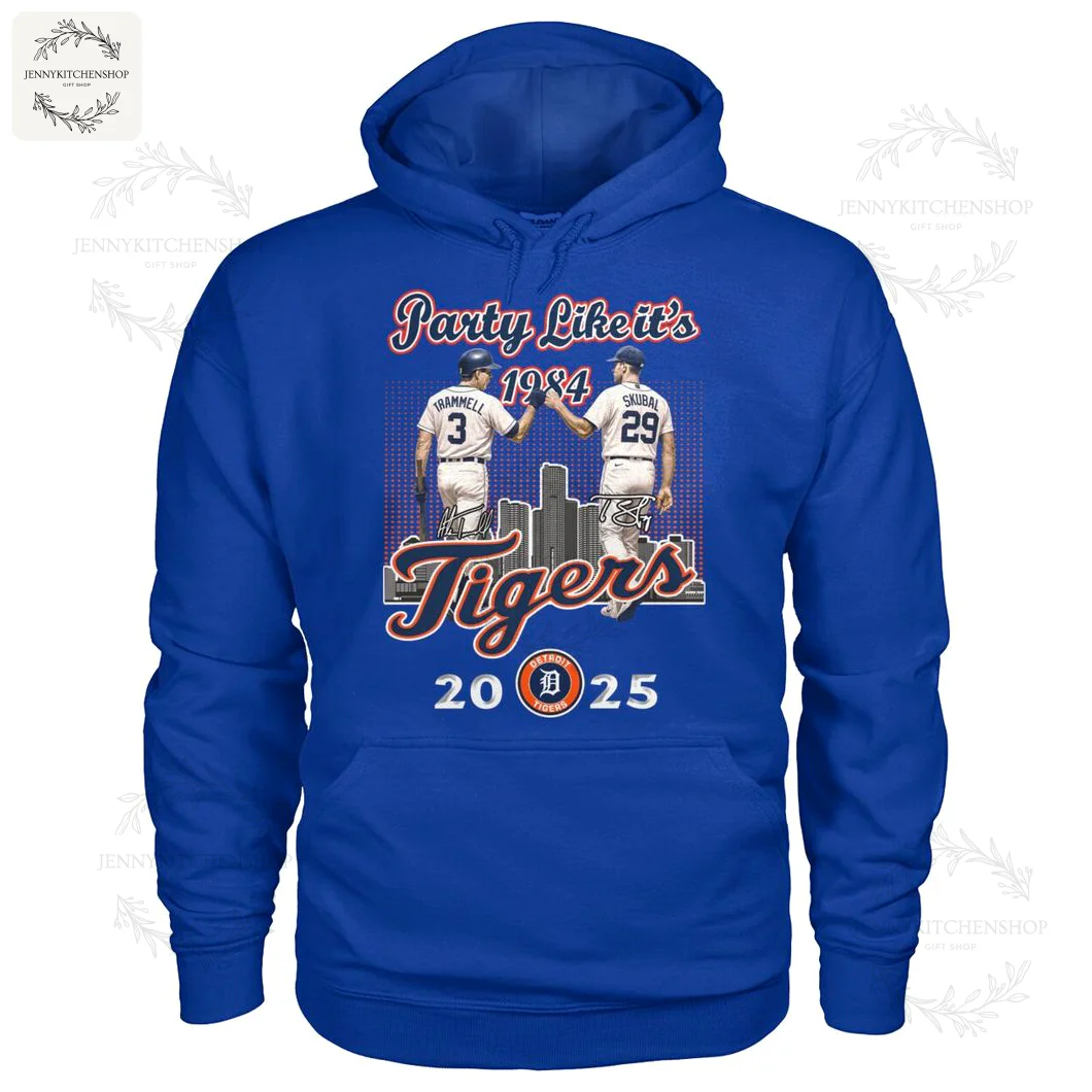 Blue hoodie decorated with two baseball players high-fiving, featuring city skyline and anniversary years, celebrating Detroit Tigers history.