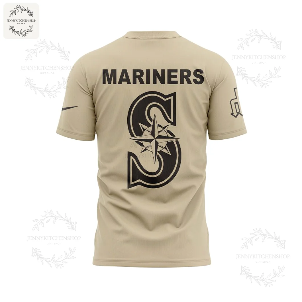 Back of the tan Seattle Mariners t-shirt with 'MARINERS' text and the team's large 'S' compass rose logo in black.