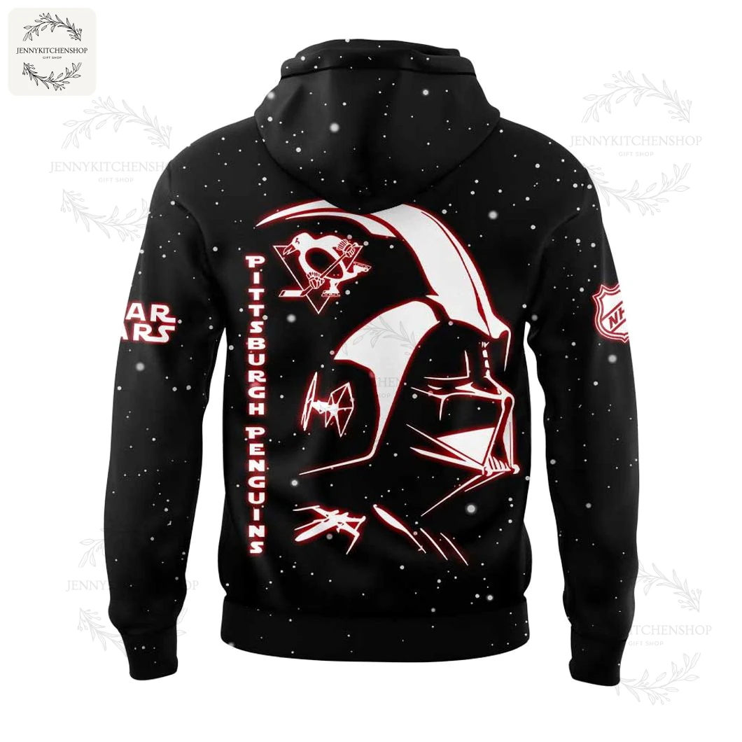 Back view of black hoodie featuring a large stylized red-outline Darth Vader helmet, Pittsburgh Penguins logo, TIE fighter accents, vertical "Pittsburgh Penguins" lettering and scattered space-like speckle pattern.