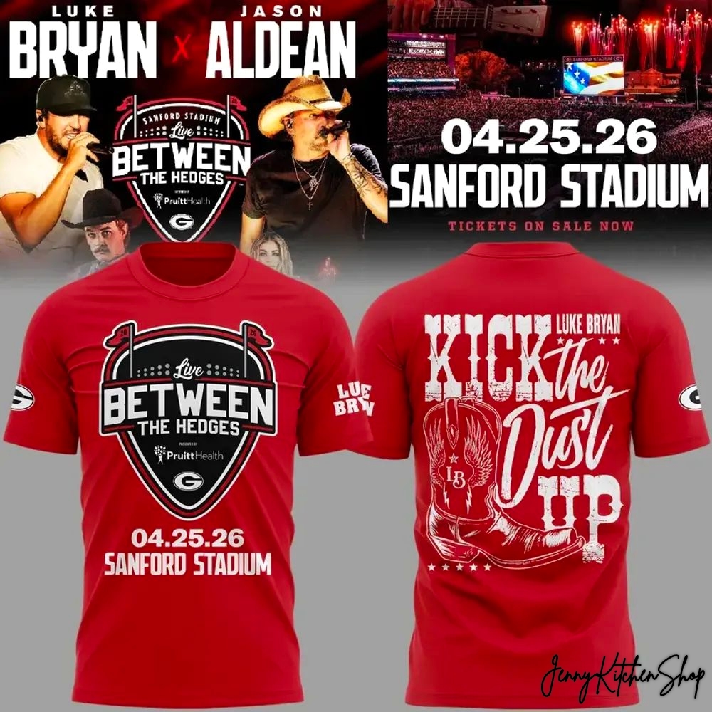 Red 3D t-shirt mockup featuring Luke Bryan and Jason Aldean for the 2026 "Between the Hedges" tour at Sanford Stadium on 04.25.26. The front design shows a shield logo with "Live Between the Hedges", the PruittHealth logo, and the date. The back design has "Luke Bryan Kick the Dust Up" with a cowboy boot graphic.